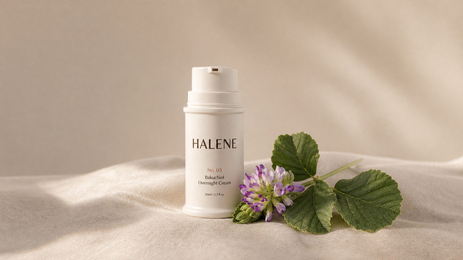 HALENE No. 03 Overnight Cream with a fresh babchi sprig and purple flower on cream linen