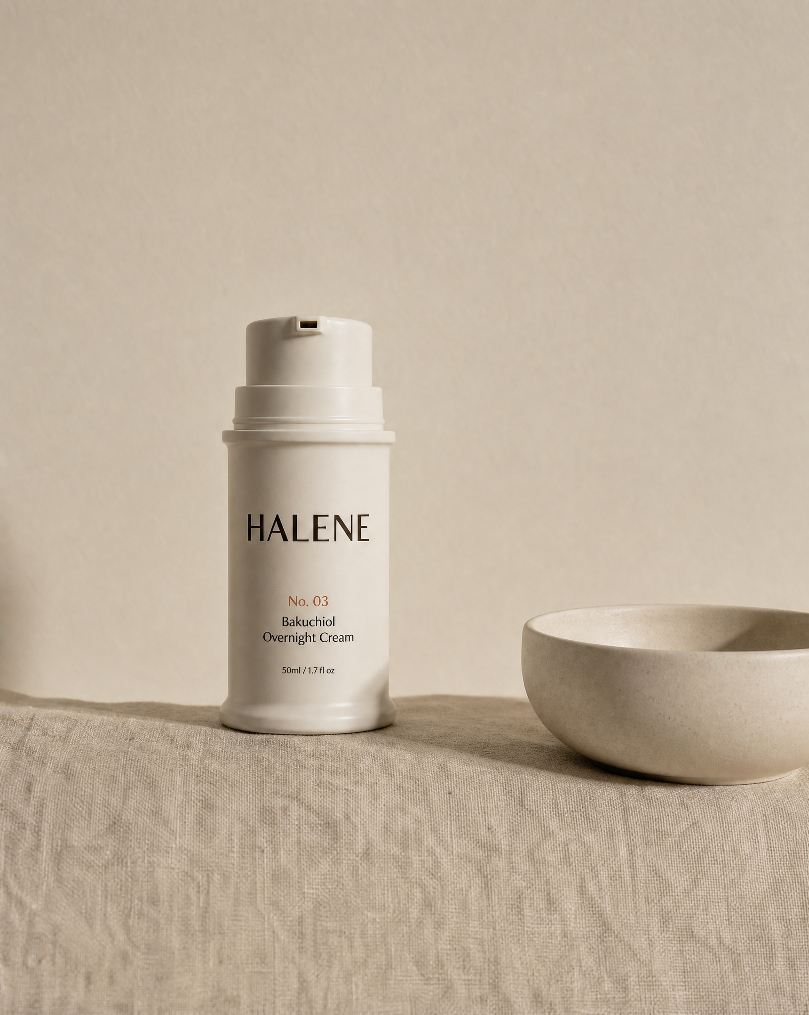 HALENE No. 03 Bakuchiol Overnight Cream on linen beside a ceramic bowl