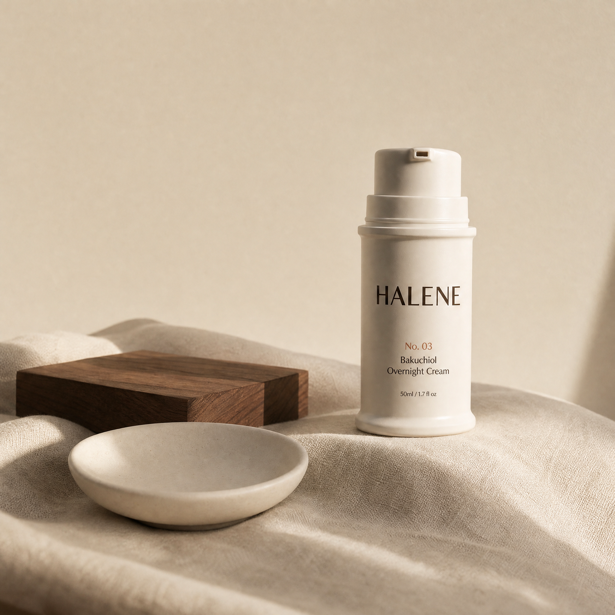 HALENE No. 03 Bakuchiol overnight cream on natural linen with a ceramic dish and walnut block